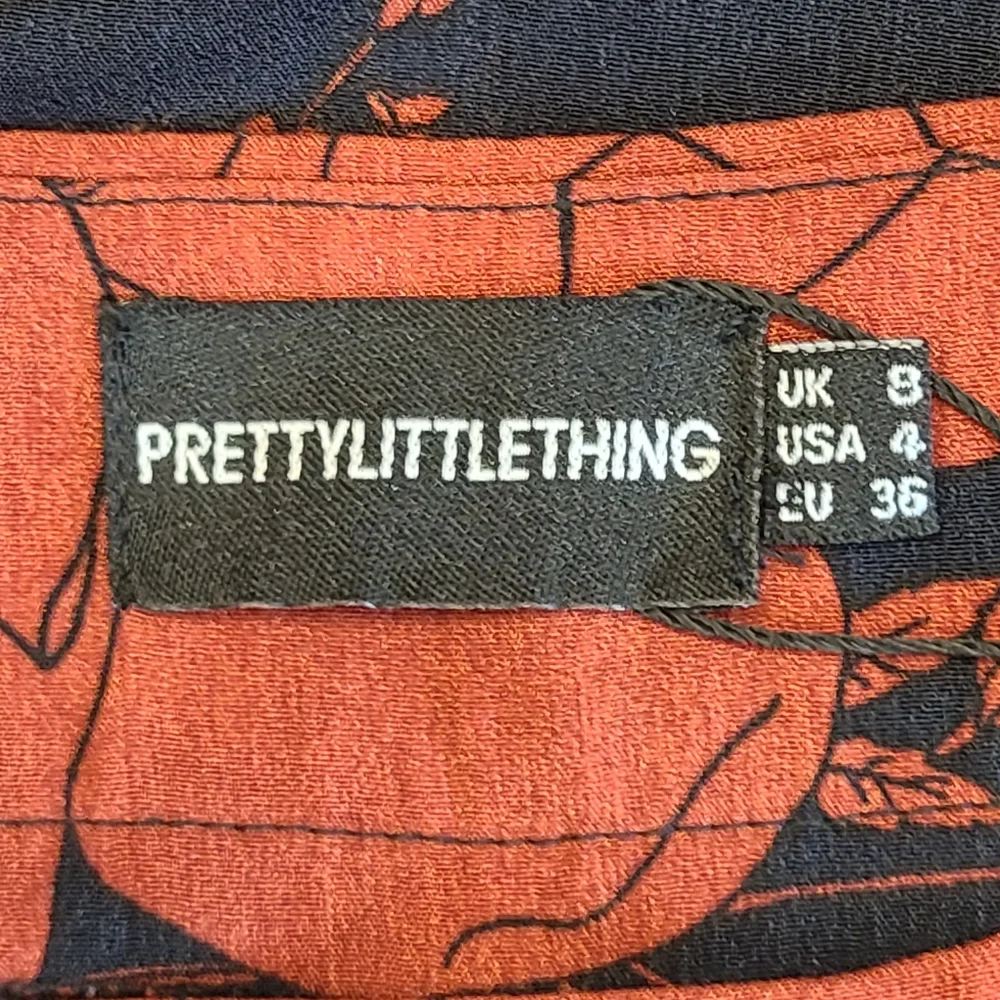 PrettyLittleThing Navy Rust Red Tropical Floral Print Flared Wide Leg Pants 4 - Picture 8 of 13